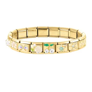 Detail of golden stainless steel Italian charm bracelet with floral and rhinestone charms