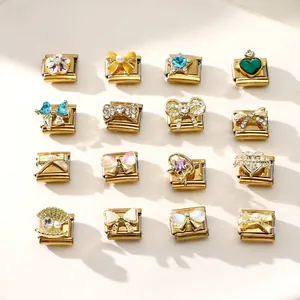 Macro view of 16 assorted gold Italian charms with crystal and enamel DIY jewelry details