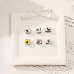 Detail of six black cat enamel charms on modular stainless steel Italian bracelet links