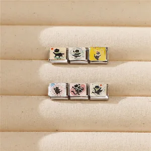 Macro view of Italian charm links with cute black cat illustrations in colorful enamel