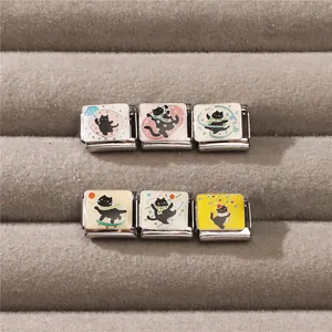 Detail of 6 creative Italian charm links with cute black cat designs on velvet tray