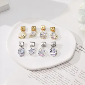 Macro detail of 8pcs celestial Italian charms with astronaut and planet enamel motifs