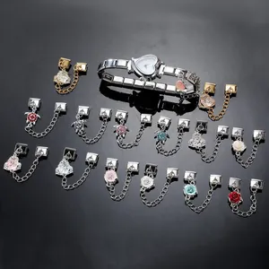Macro view of modular heart watch link with rhinestone rose and turtle charms