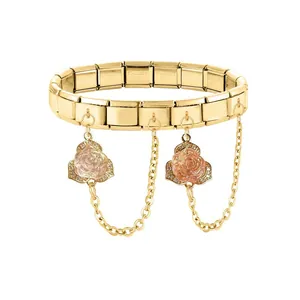 Detail of gold modular bracelet link featuring pink rose charms and crystal accents