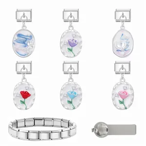 Close-up of stainless steel modular charm links with colorful flower and shell patterns