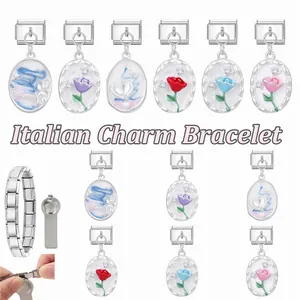 Macro view of modular Italian charm bracelet links and colorful rose flower pendants