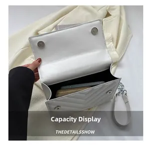 Close-up of quilted white flap bag showing capacity for phone and long wallet