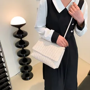 Minimalist cream woven tote straw crossbody bag with chevron pattern on model