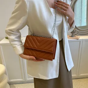 Chic brown quilted crossbody bag with stylish silver chain strap and flap closure