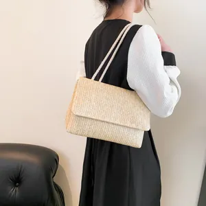 Minimalist beige woven straw tote bag with V-shaped texture and white rope shoulder straps