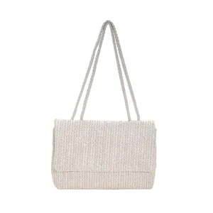 Minimalist straw tote bag with shoulder straps and woven flap design for summer