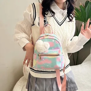 Detail of macaron tie-dye nylon backpack featuring white stars and a plush heart pendant