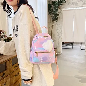 Detail of mini gradient nylon backpack featuring star and heart prints with heart plush charm