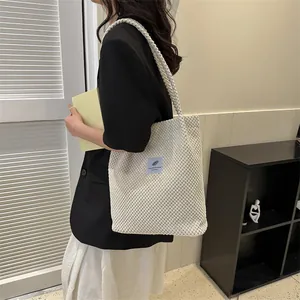 Chic cream white waffle texture tote bag with blue label for women on stylish shoulder