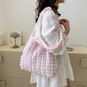 Detail view of pink and white striped bubble texture canvas tote bag with shoulder strap