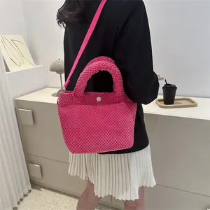 Detalle de bolso saco rosa con textura de burbujas y correa de hombro ajustable
