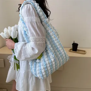 Detail of blue and white bubble texture tote bag showing its unique pleated canvas surface