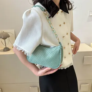 Chic light green woven hobo bag with a stylish gold and resin chunky chain strap