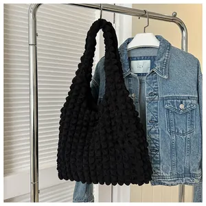 Detailed view of black bubble textured fabric on a casual shoulder tote bag