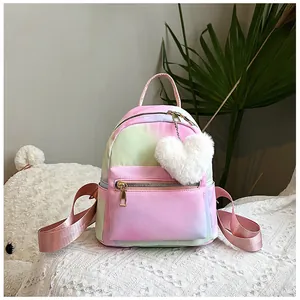 Detail of colorful gradient nylon backpack with gold zipper and white heart plush keychain