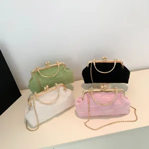 Detail view of ruched dumpling bags in four colors with gold metal clasp and chain straps
