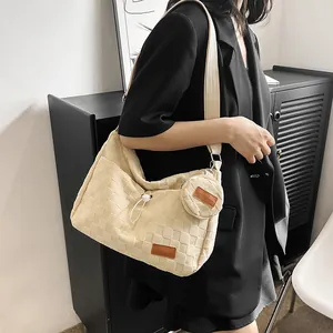 Detail of cream canvas tote bag showing relief checkered texture and detachable round pouch