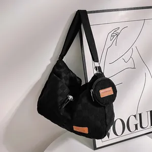 Detail of black checkered canvas tote bag with wide strap and round coin purse