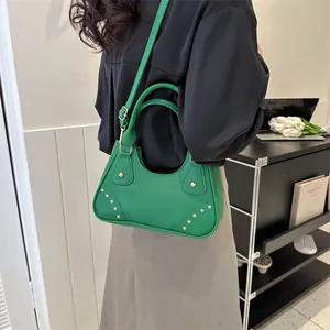 Borsa a tracolla verde acceso in pelle con borchie dorate e tracolla regolabile