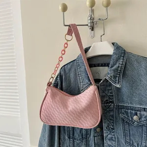 Detail of pink woven hobo bag featuring dual straps and textured synthetic leather surface