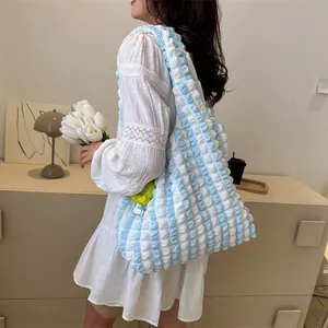 Blue and white cloud bubble tote bag with plaid texture shown on female model