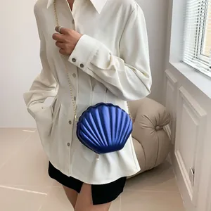 Chic shell shaped crossbody bag in metallic blue with gold chain and pearl detail