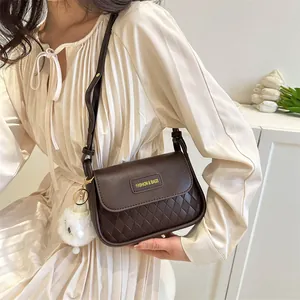 Elegant dark brown quilted crossbody bag shown on model in a minimalist setting