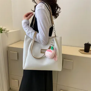 White large capacity tote bag with PU leather texture and peach plush charm detail