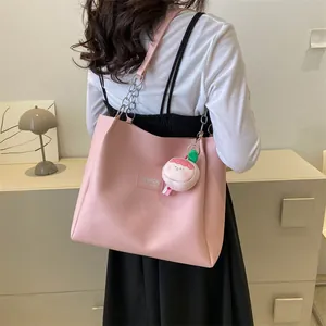 Pink large capacity faux leather tote bag with chain strap and strawberry pendant detail