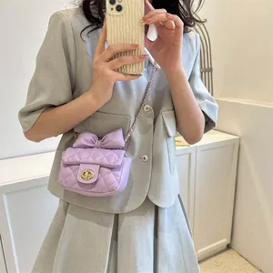 Lavender quilted mini crossbody bag with bow decoration and gold chain strap
