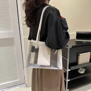 Detailed view of clear PVC tote bag with cream leather trim and inner privacy pocket