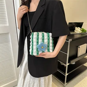 Green and white striped bubble texture crossbody bag with floral detail and gold chain