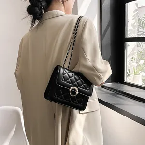 Elegant black quilted crossbody bag with pearl buckle and metal chain strap for women