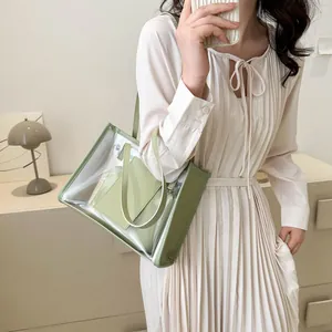 Detail of light green transparent PVC tote bag featuring matching leather inner pouch