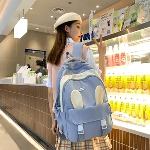 Detail of cute blue and white school backpack with rabbit ears and buckle closure
