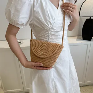 Summer woven floral bucket bag in light brown with delicate metal buckle and rope strap