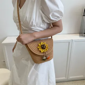 Detailed close-up of woven flower bucket bag with sunflower decor on white dress