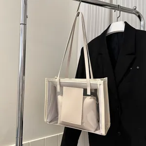 Detail of transparent PVC tote bag with cream leather inner pouch on a black blazer