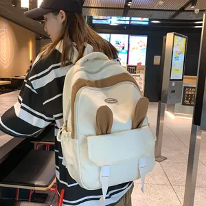 Fashionable beige backpack with cute bunny ears and brown trim for students