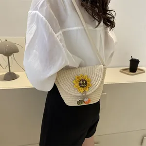 Summer straw bucket bag with sunflower decor and colorful charms on a shoulder strap