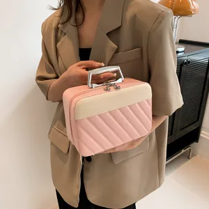 Detail of pink quilted handbag with sleek metal handle and floral zipper charm