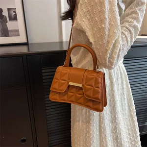 Elegant caramel brown quilted shoulder bag with gold clasp and top handle for women