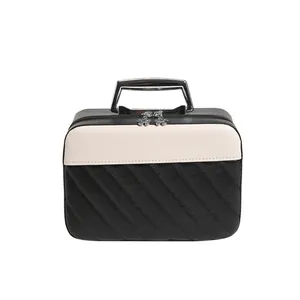 Chic black and white striped box handbag with quilted pattern and flower zipper detail