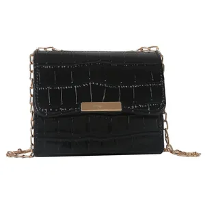 Chic black crocodile embossed crossbody bag with gold chain strap and metallic buckle