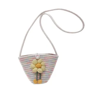 Mini straw woven bucket bag with colorful wavy patterns and a yellow sunflower for kids